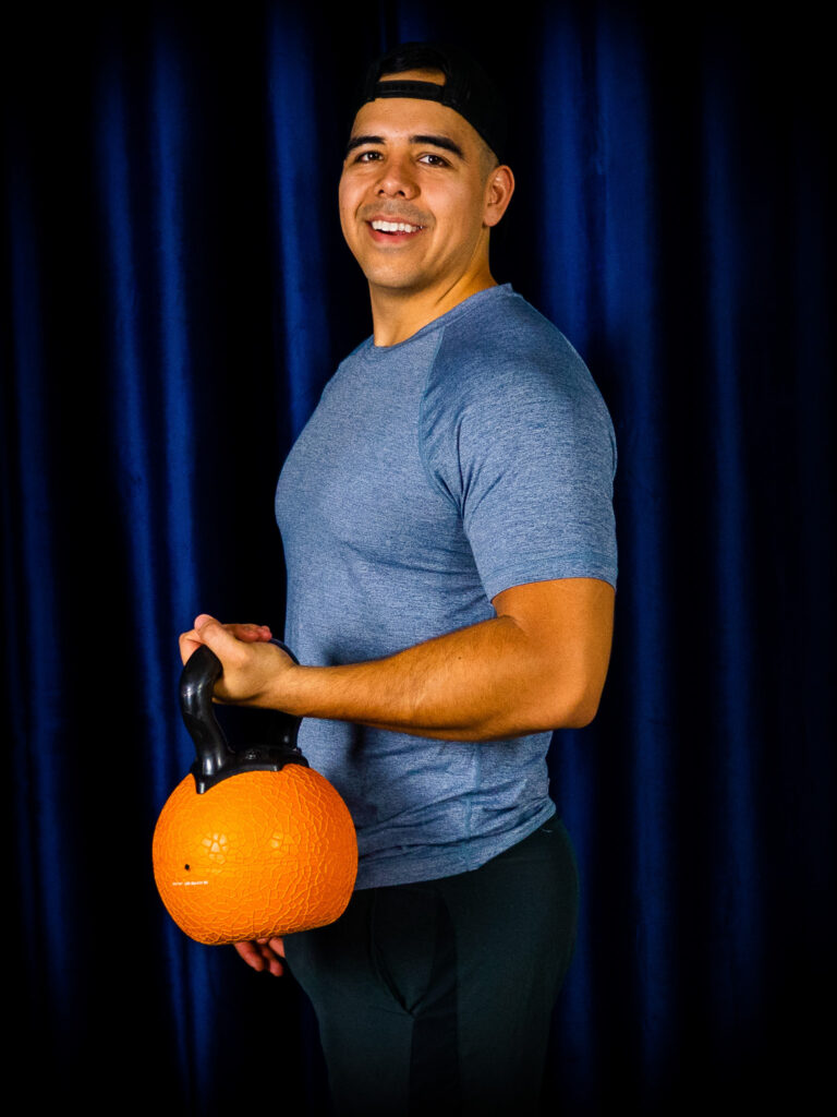 Danny curling a kettlebell performing functional movement and exercise