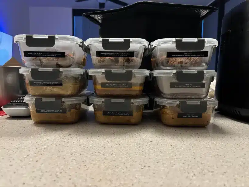 a stack of plastic containers with food in them